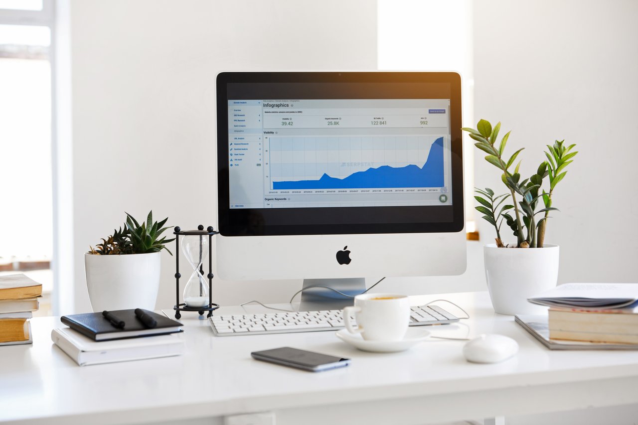 facebook marketing, an imac screen showing a rising graphic report